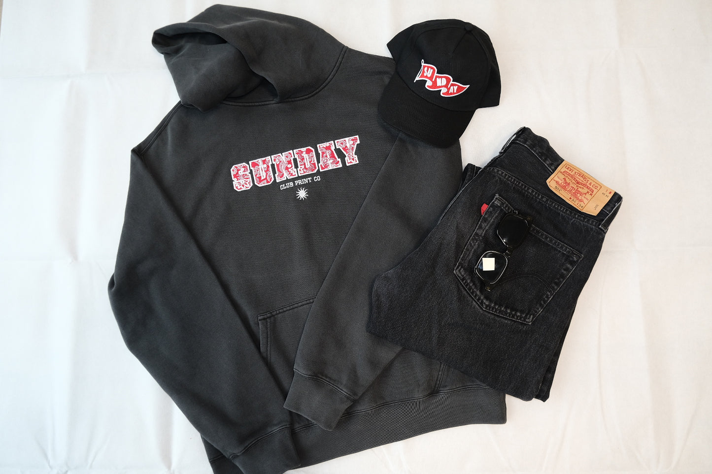 Sunday Club Embroidered Varsity Hoodie in Faded Black.
